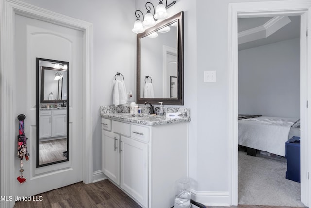 full bathroom with vanity, wood finished floors, ensuite bathroom, and crown molding