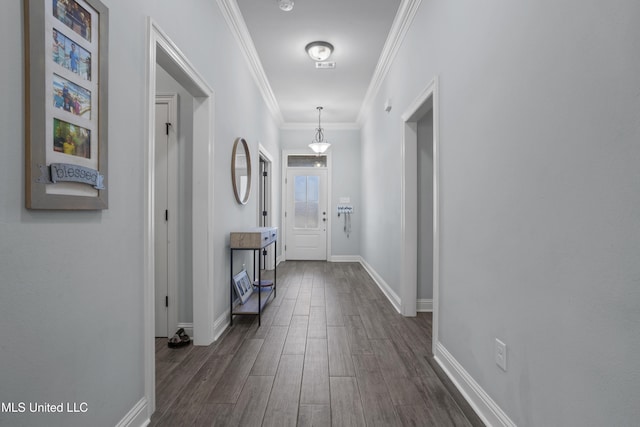 interior space with baseboards, dark wood-style flooring, and crown molding