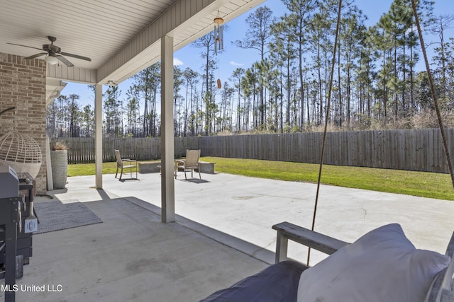 view of patio with a fenced backyard and ceiling fan