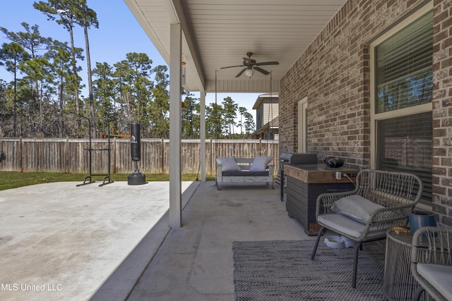 view of patio featuring an outdoor living space, a ceiling fan, and fence