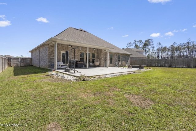 rear view of property featuring a fenced backyard, a patio, brick siding, and ceiling fan