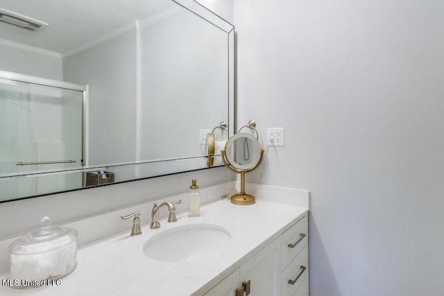 bathroom with vanity, ornamental molding, and a shower with shower door