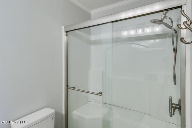 full bath featuring ornamental molding, a stall shower, and toilet