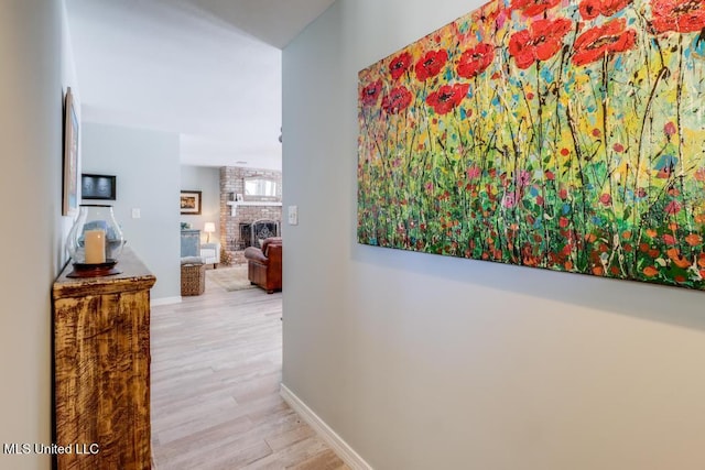 hall featuring wood finished floors and baseboards