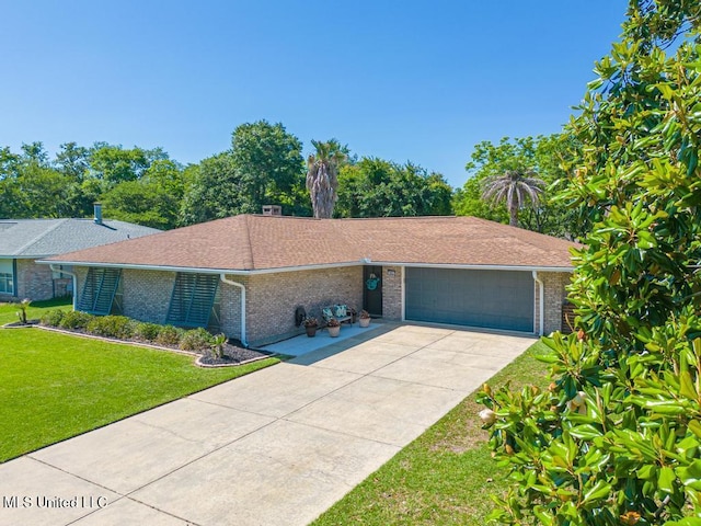 single story home with an attached garage, brick siding, a front lawn, and concrete driveway