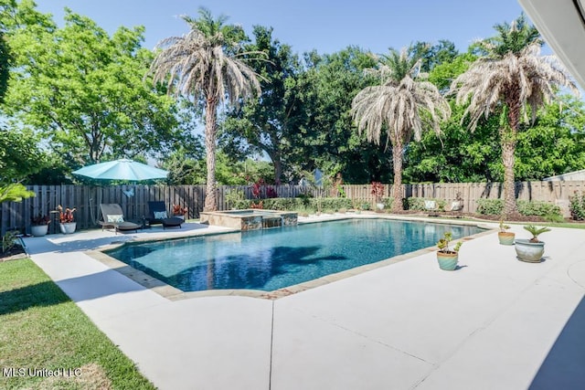 view of pool with a patio area, a fenced backyard, and a pool with connected hot tub