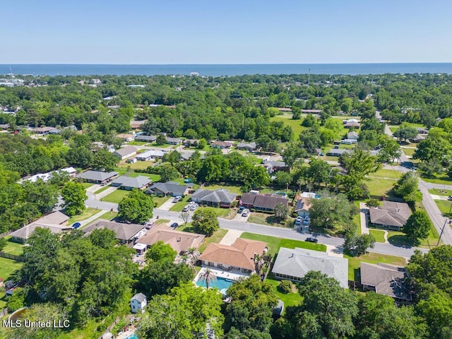 aerial perspective of suburban area with a large body of water