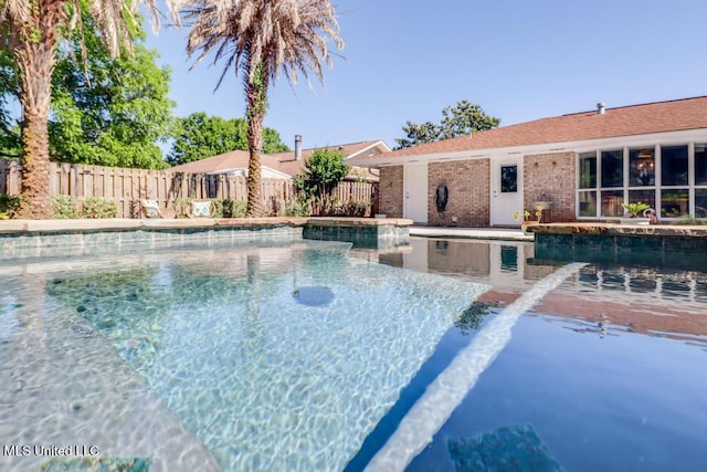 view of pool featuring a fenced backyard and a jacuzzi