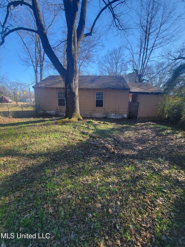 view of side of property with a lawn