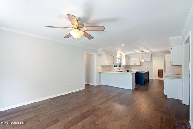 kitchen featuring white cabinetry, kitchen peninsula, pendant lighting, and dark hardwood / wood-style flooring