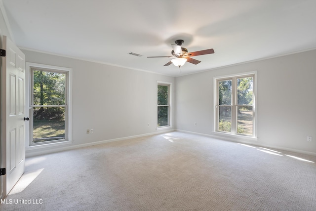 spare room with crown molding, light colored carpet, and ceiling fan