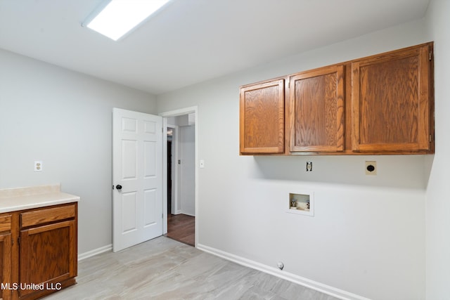 laundry area with light hardwood / wood-style flooring, electric dryer hookup, washer hookup, and cabinets