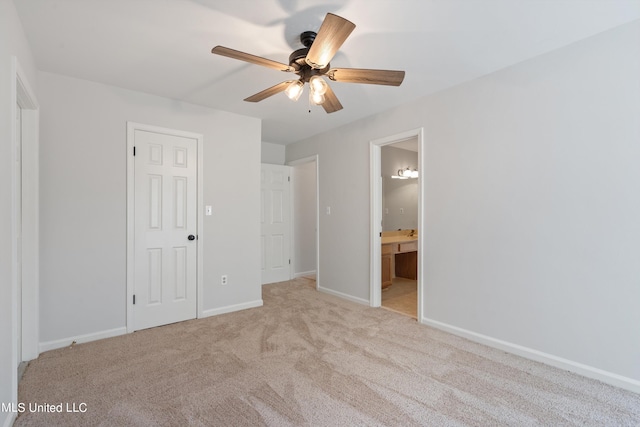 unfurnished bedroom with light colored carpet, ceiling fan, a closet, and ensuite bath