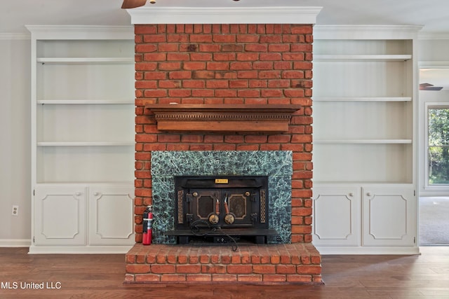 room details with crown molding, hardwood / wood-style flooring, and built in features