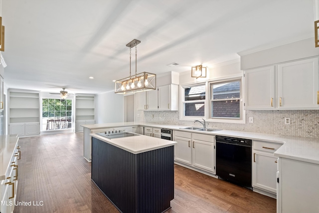 kitchen with dishwasher, kitchen peninsula, hardwood / wood-style floors, decorative light fixtures, and white cabinets