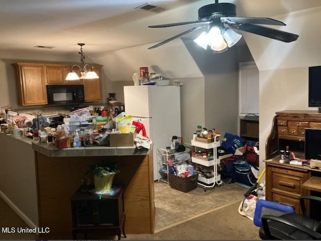 kitchen featuring decorative light fixtures, visible vents, brown cabinetry, freestanding refrigerator, and black microwave