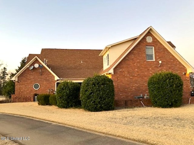 view of side of property featuring brick siding