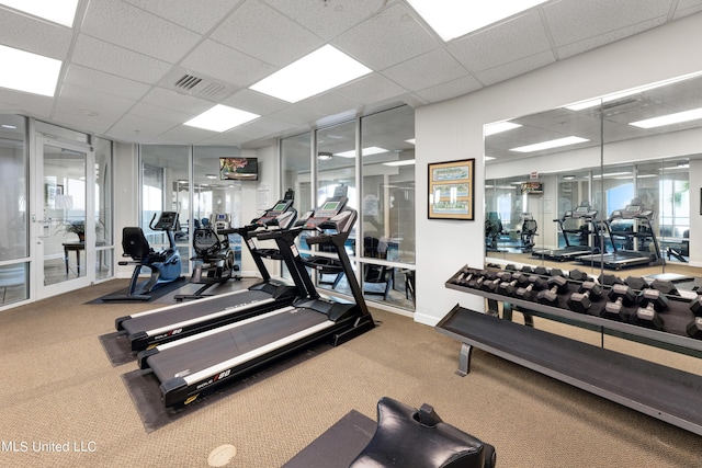 gym with visible vents, carpet flooring, and a drop ceiling