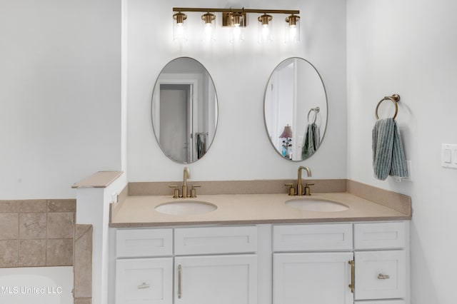 full bath with a bathtub, a sink, and double vanity