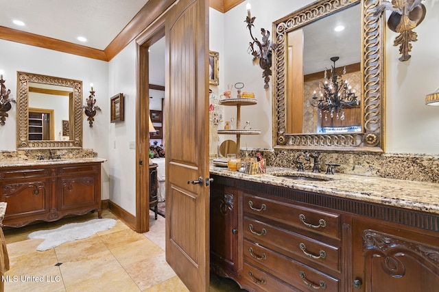 bathroom featuring tile patterned floors, vanity, ornamental molding, and a chandelier