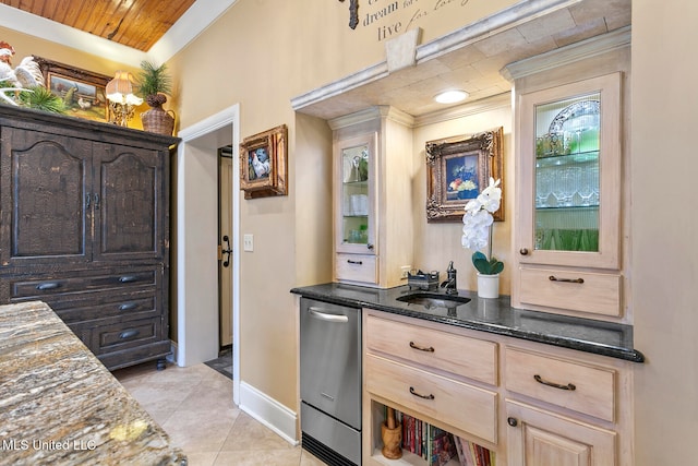 bar with sink, dark stone countertops, light brown cabinetry, dark brown cabinets, and light tile patterned flooring