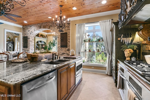 kitchen with wooden ceiling, ceiling fan with notable chandelier, dark stone countertops, light tile patterned floors, and appliances with stainless steel finishes