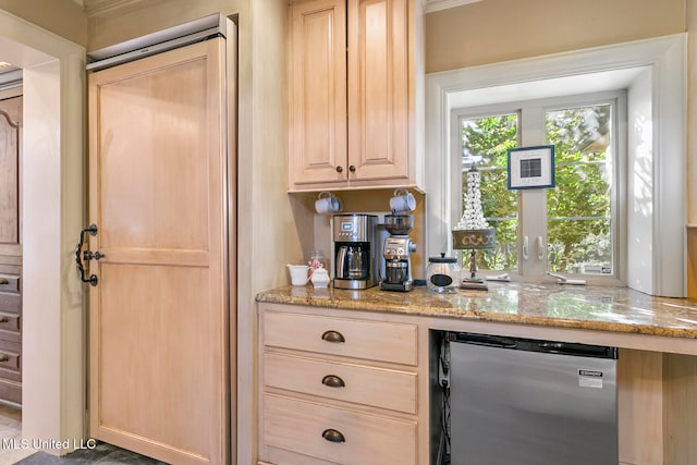 bar with light stone counters, light brown cabinets, and stainless steel dishwasher