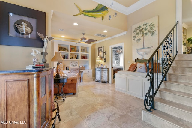 office space featuring ceiling fan, ornamental molding, and built in shelves