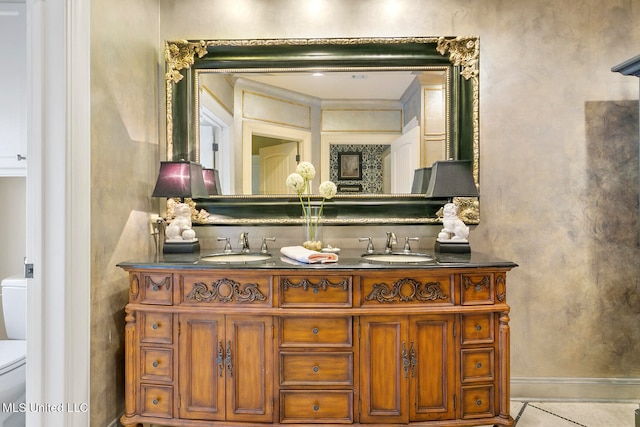 bathroom featuring tile patterned flooring, vanity, and toilet