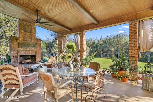 view of patio / terrace with an outdoor living space with a fireplace and ceiling fan