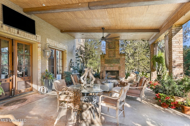 view of patio / terrace featuring ceiling fan, french doors, and an outdoor brick fireplace