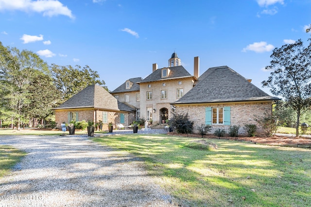 french country style house with a front yard