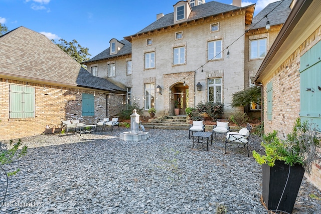 rear view of house featuring a patio and an outdoor hangout area