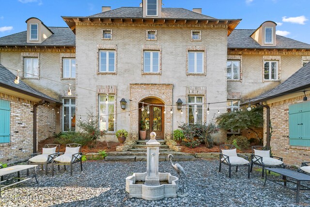 rear view of house with french doors and a patio