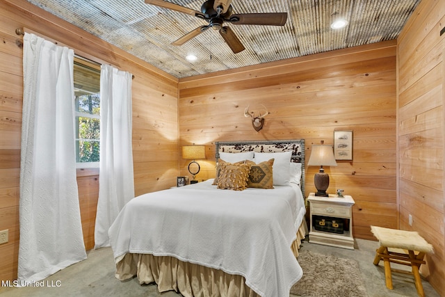 carpeted bedroom with wooden walls and ceiling fan