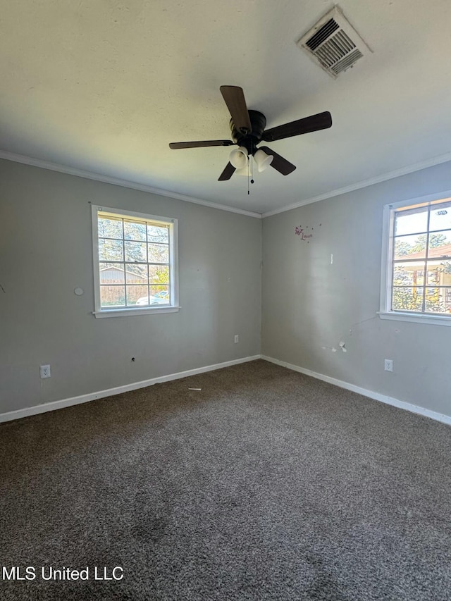 carpeted empty room featuring visible vents, plenty of natural light, and crown molding