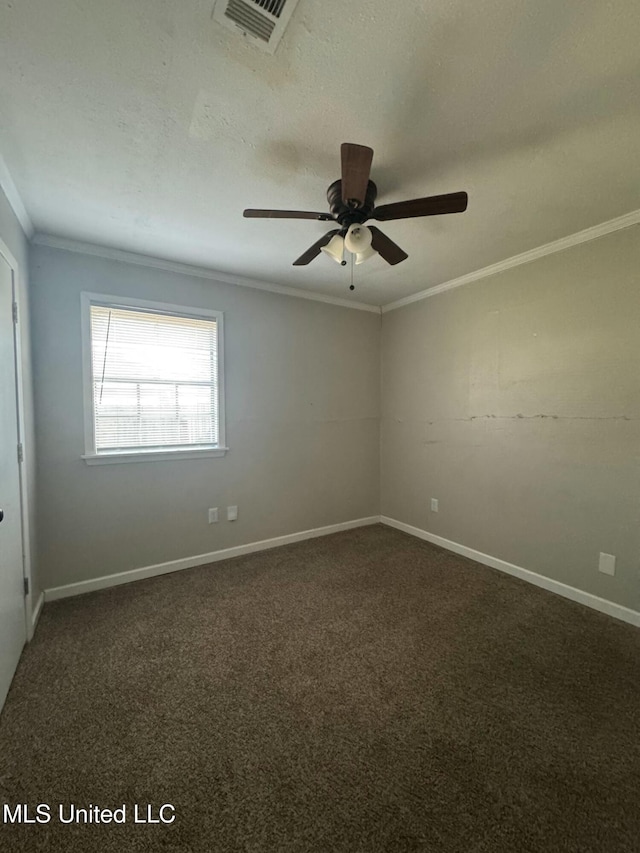 unfurnished room featuring baseboards, visible vents, ornamental molding, a textured ceiling, and dark carpet