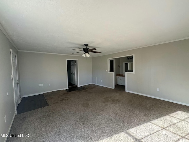 unfurnished room featuring carpet flooring, ceiling fan, baseboards, and ornamental molding