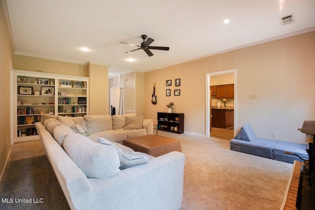 living room with visible vents, light carpet, a ceiling fan, recessed lighting, and crown molding