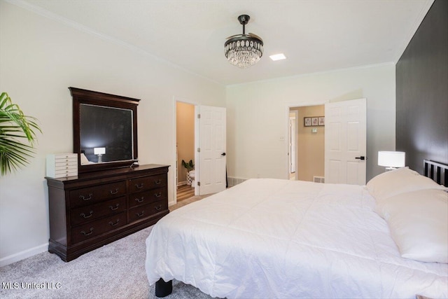 bedroom featuring visible vents, baseboards, carpet floors, and crown molding