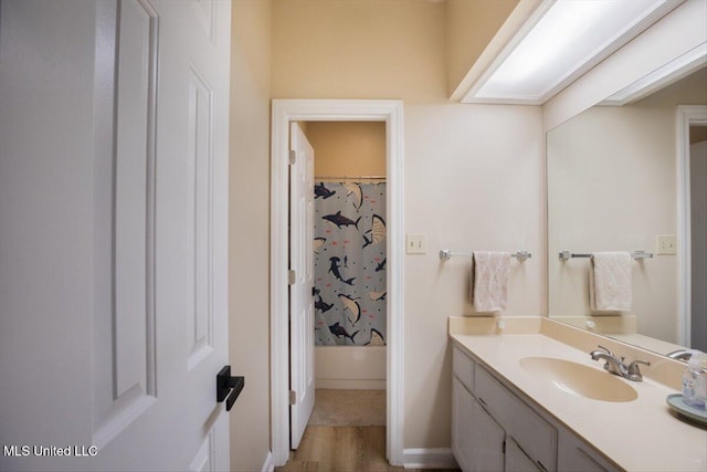 bathroom featuring shower / bath combo and vanity