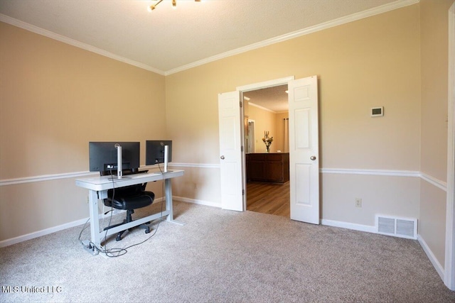 carpeted office with crown molding, baseboards, and visible vents