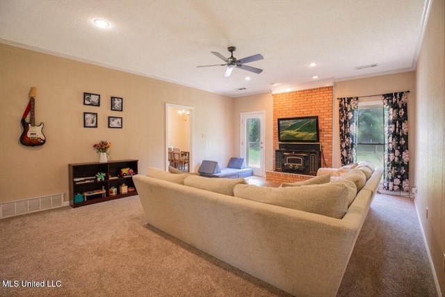 carpeted living area featuring a healthy amount of sunlight, visible vents, and ceiling fan