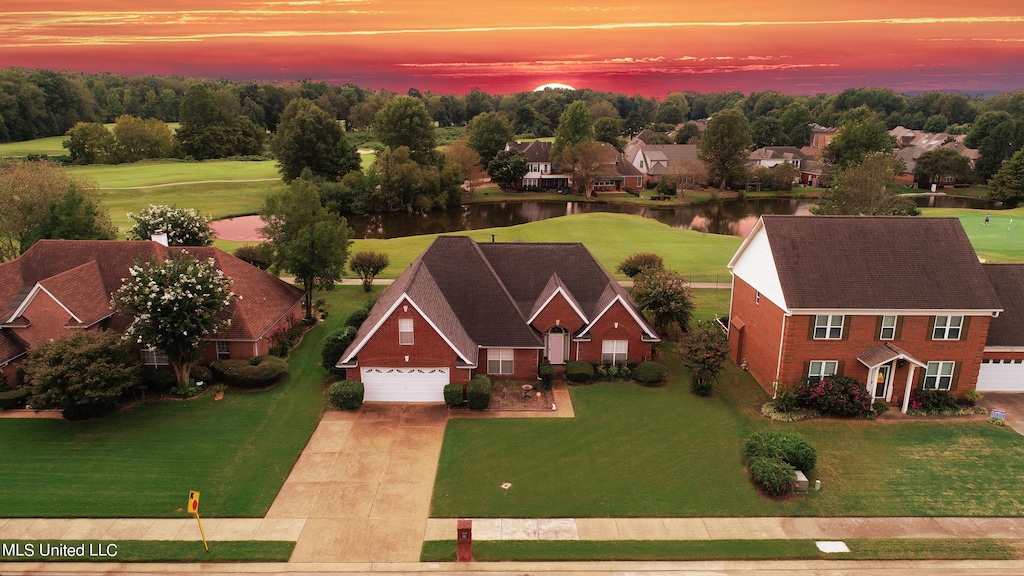 aerial view at dusk with a water view