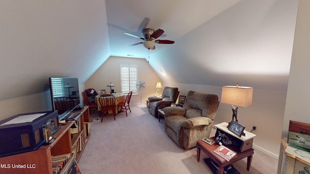 carpeted living room with ceiling fan and vaulted ceiling