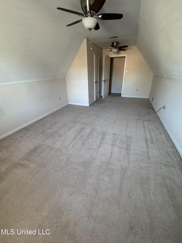 bonus room with light colored carpet, vaulted ceiling, and ceiling fan