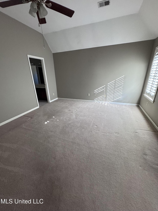 empty room with carpet flooring, ceiling fan, and vaulted ceiling