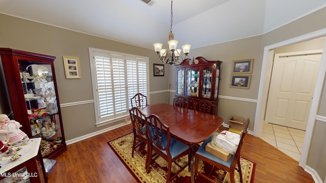 dining space with a notable chandelier and dark hardwood / wood-style flooring