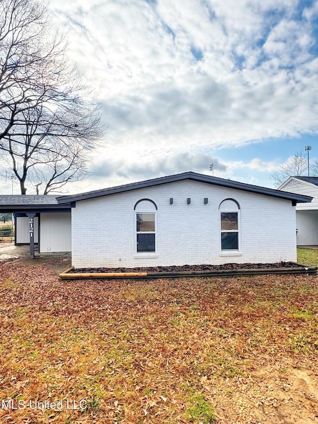 view of home's exterior with a carport