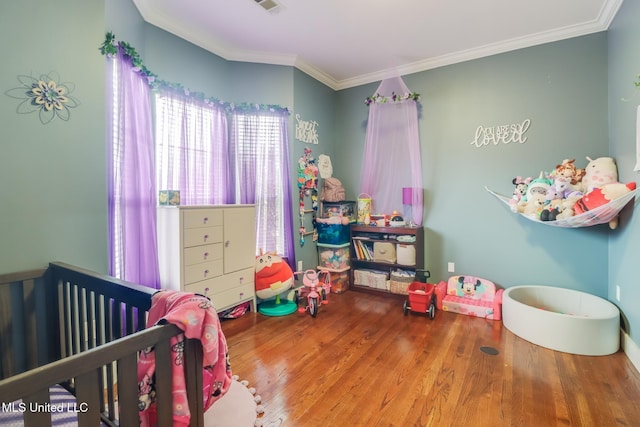 bedroom featuring ornamental molding and wood-type flooring